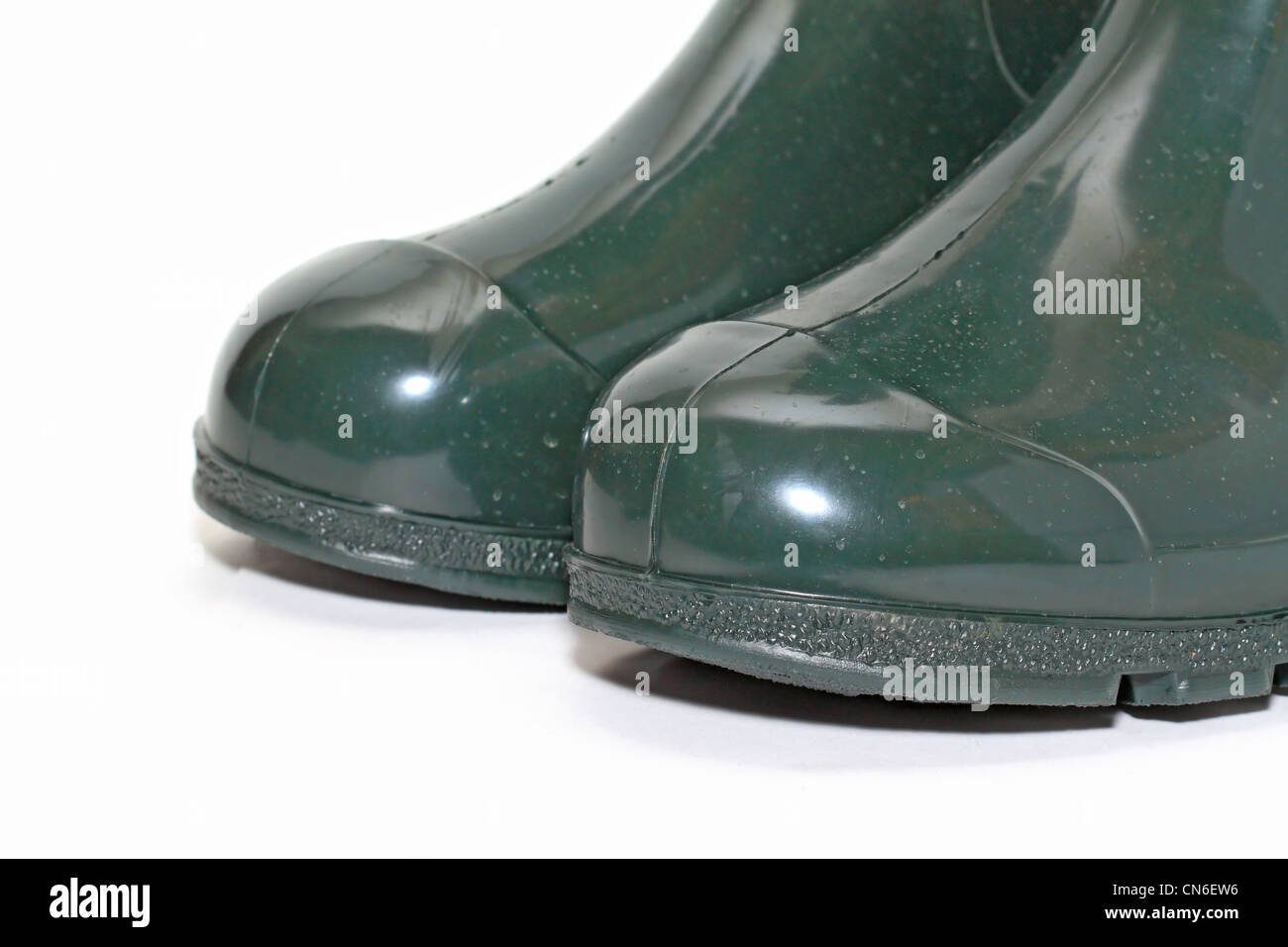 green rubber boots on white background Stock Photo - Alamy