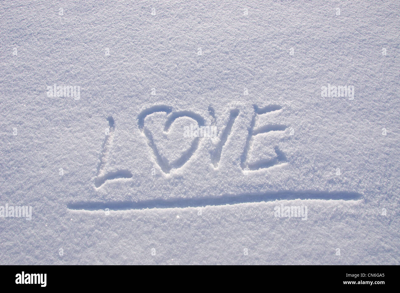 Inscription love on snow in winter. Concept expression of human feelings. Stock Photo