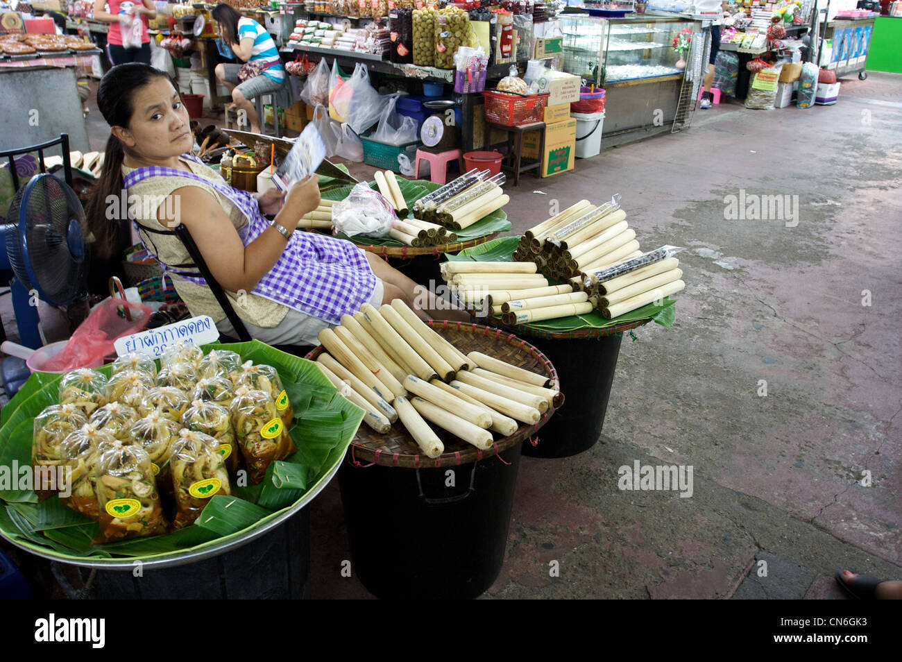 lady selling bamboo sticky rice, kow hlarm,pickled tamarin, chiang mai kad luang, chiang mai,thailand Stock Photo