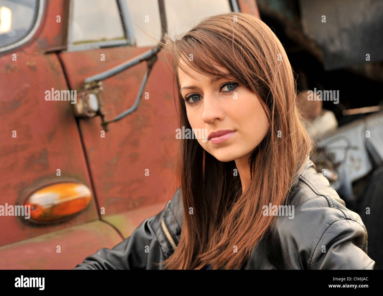 Beautiful caucasian girl on old truck background Stock Photo