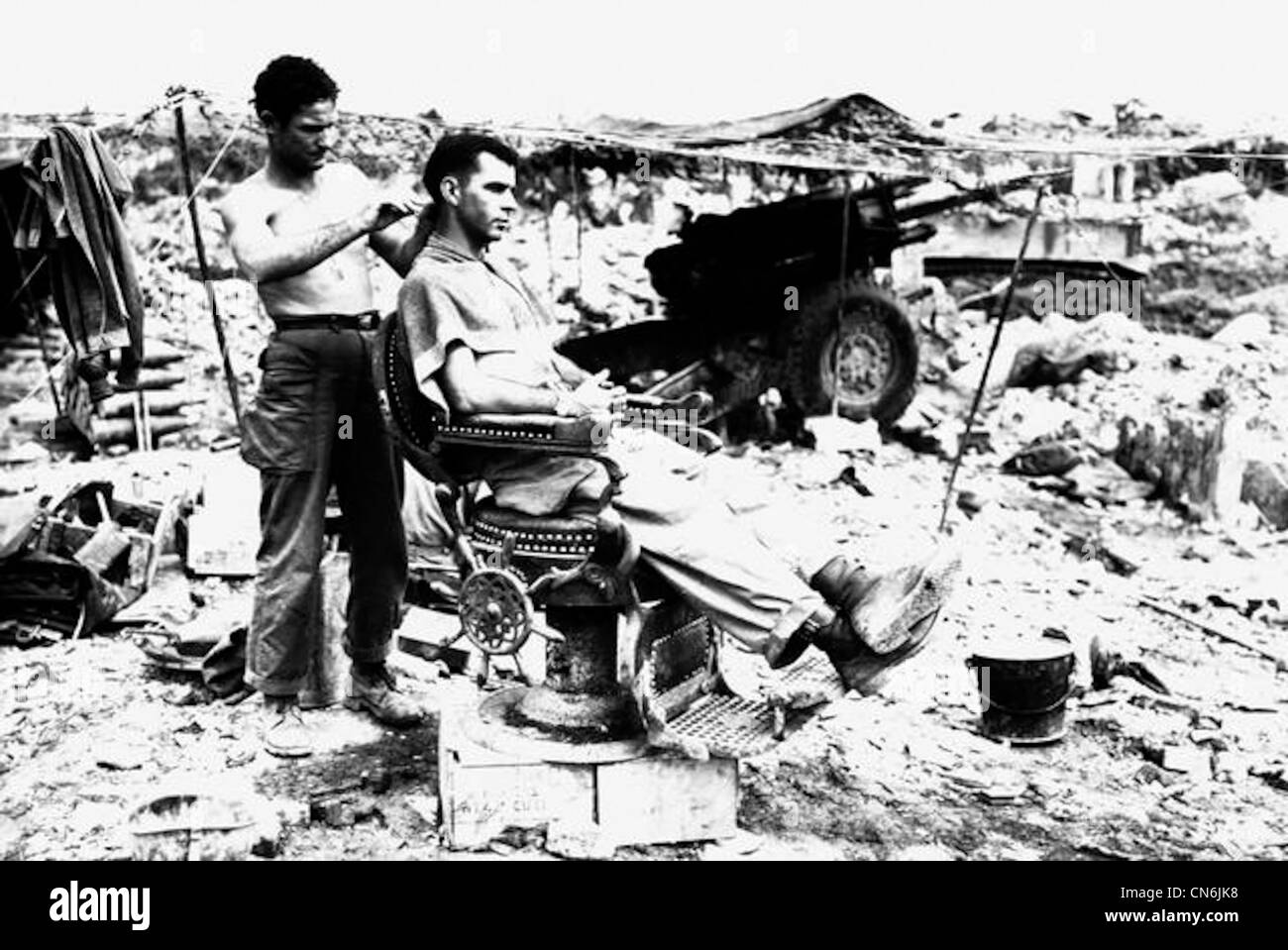 Pfc. Troy Dixon, Leadhill, Ark., uses a Japanese barber chair to cut the hair of Sgt. John Anderson, Anita, Pa. Both men are members of the 363rd . Bn., located near Shuri, Pfc. Troy Dixon, Leadhill, Ark., uses a Japanese barber chair to cut the hair of Sgt. John Anderson, Anita, Pa. Both men are members of the 363rd . Bn., located near Shuri,