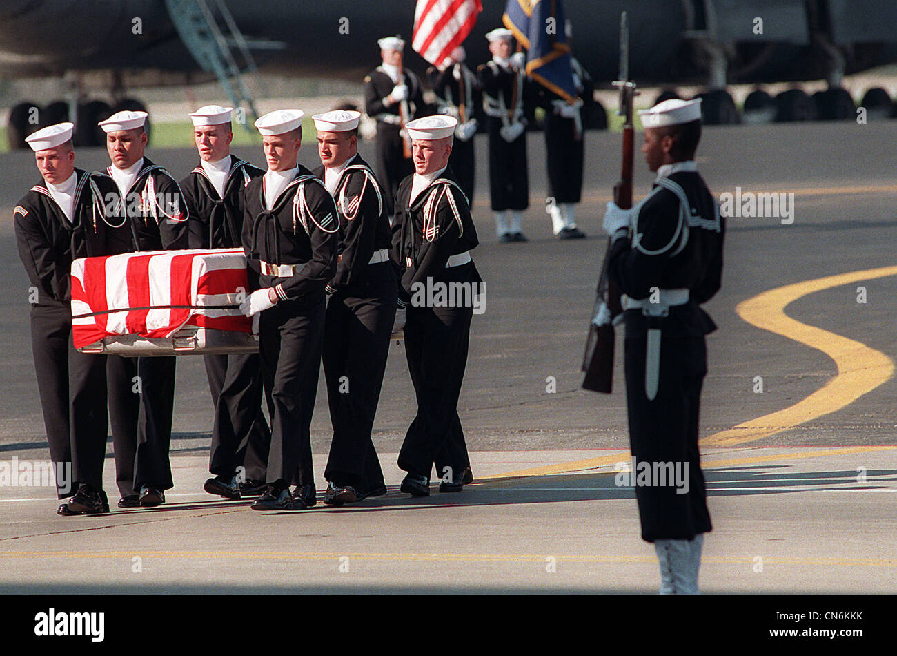 Navy pallbearers carry the remains of one of the 47 crew members killed in an explosion aboard the battleship USS IOWA (BB-61). The explosion occurred in the No. 2 16-inch gun turret as the IOWA was conducting routine gunnery exercises approximately 300 miles northeast of Puerto Rico on April 19th. Stock Photo
