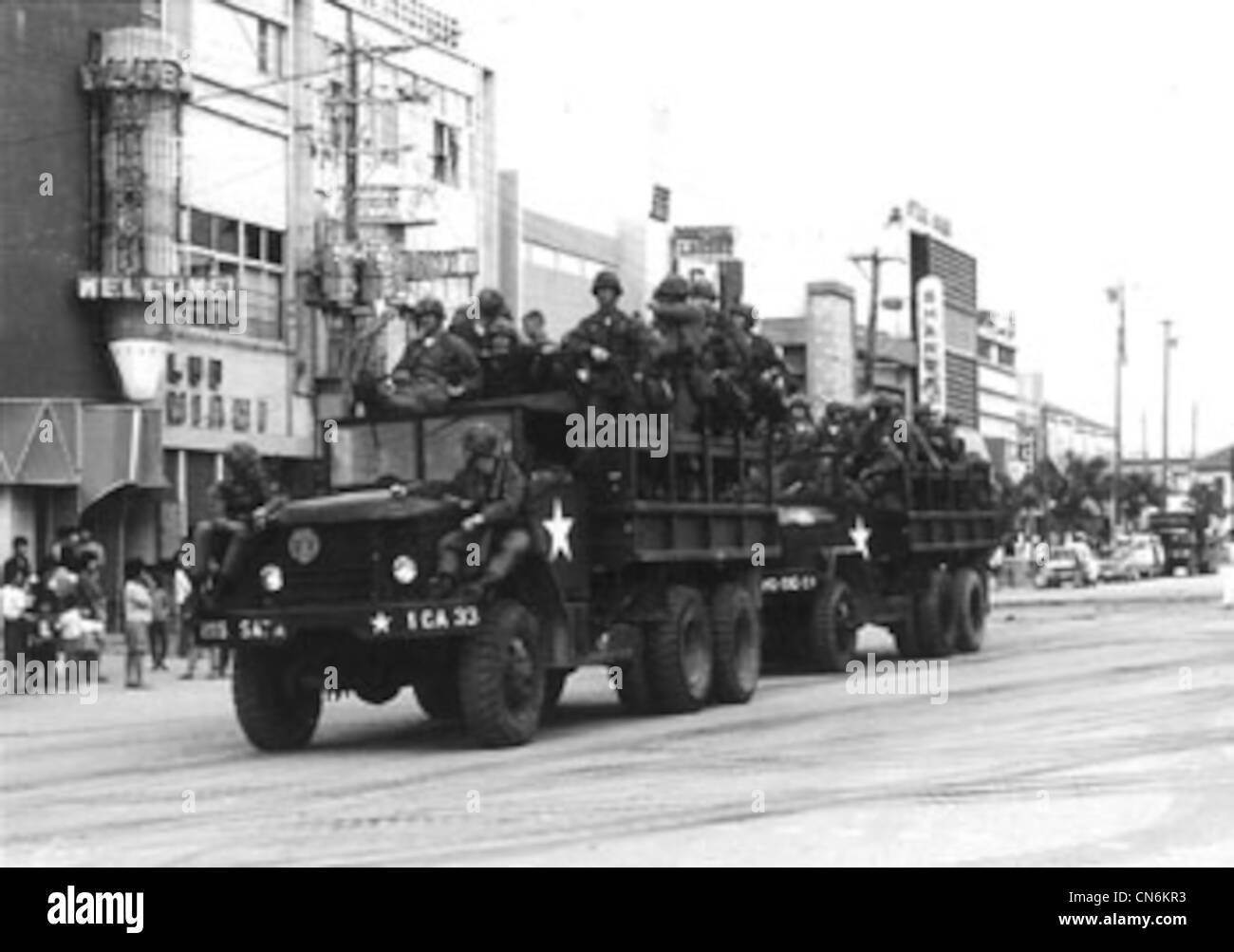 US military troops arrive on trucks in Koza, now called Okinawa City ...