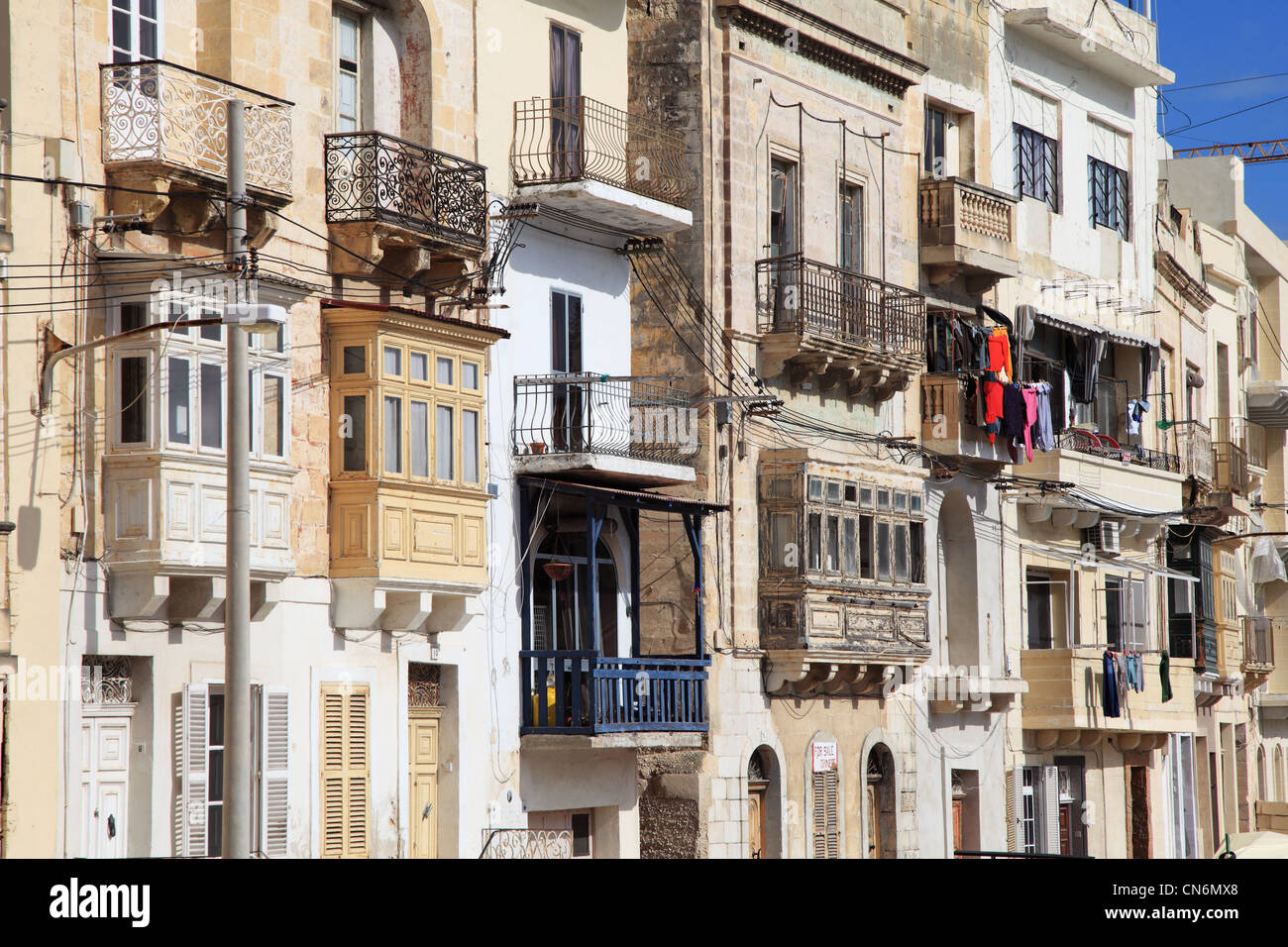 Collection of traditional Maltese town houses with balconies and bay
