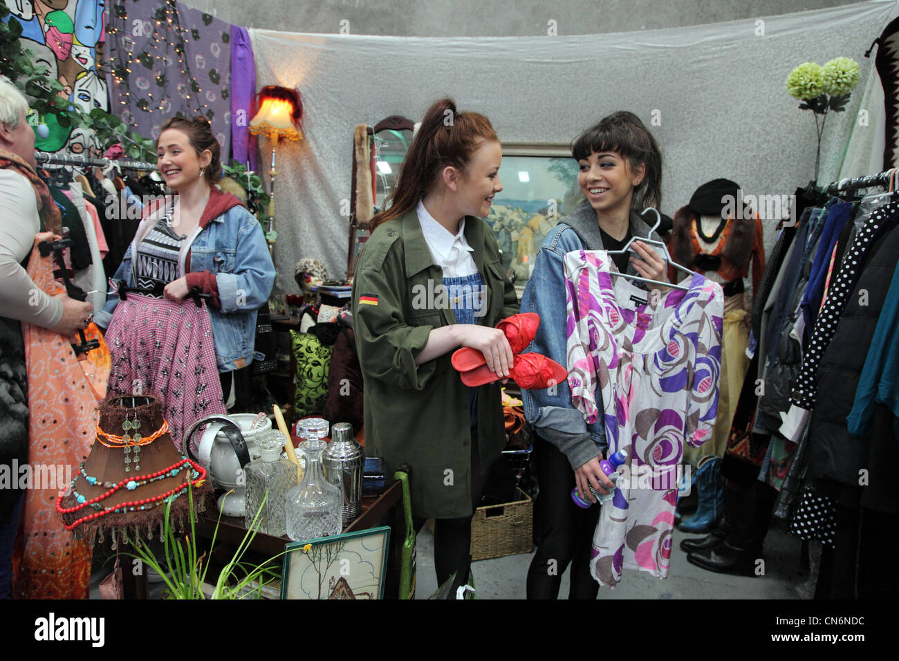 Three Irish High School girls enjoying the fashion offerings at the Merchants yard car boot sale, Dublin, Ireland Stock Photo