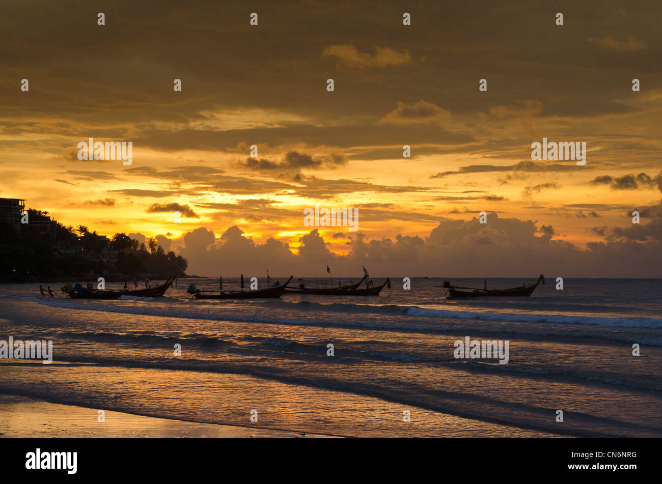 Long-tail boats at sunset, Kamala Beach, Phuket Island, Thailand Stock Photo