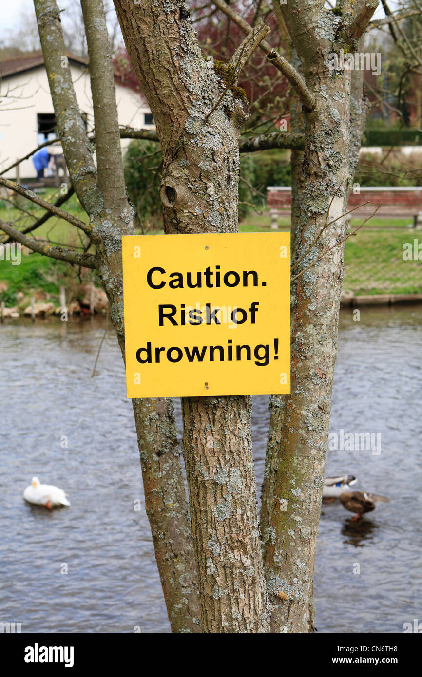 Risk of drowning sign by river Stock Photo