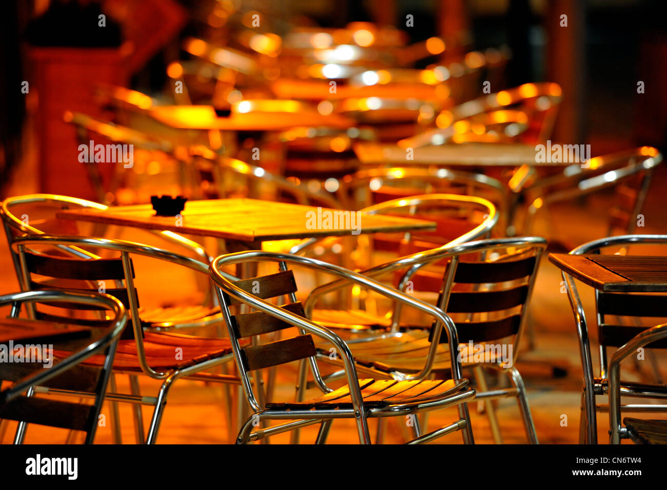 Café  empty chairs and tables at night, outside location Stock Photo