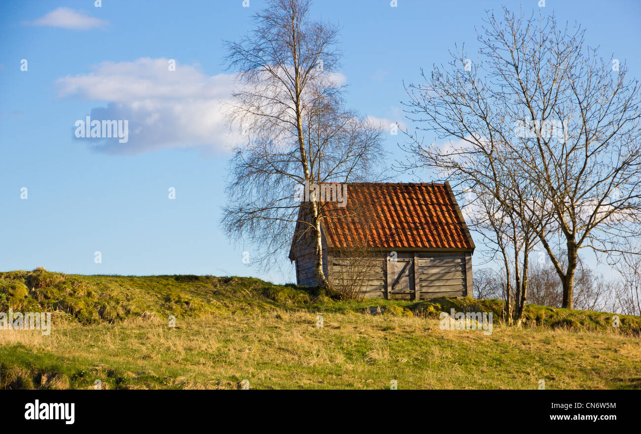 Picture of a small house on the top of a hill Stock Photo