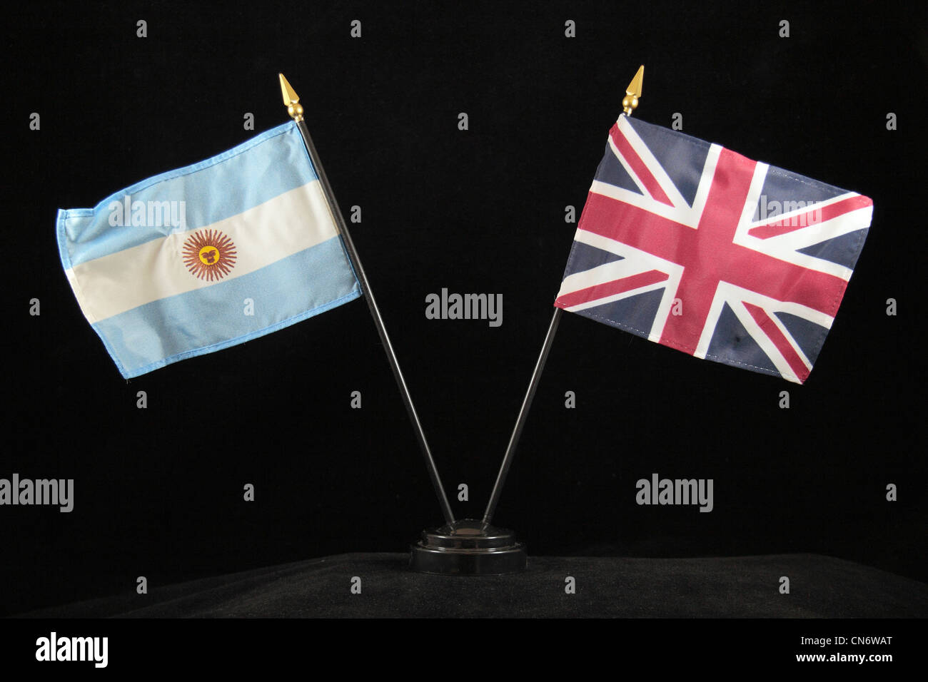 The national flags of the United Kingdom of Great Britain and Northern Ireland and Argentina on a black background. Stock Photo