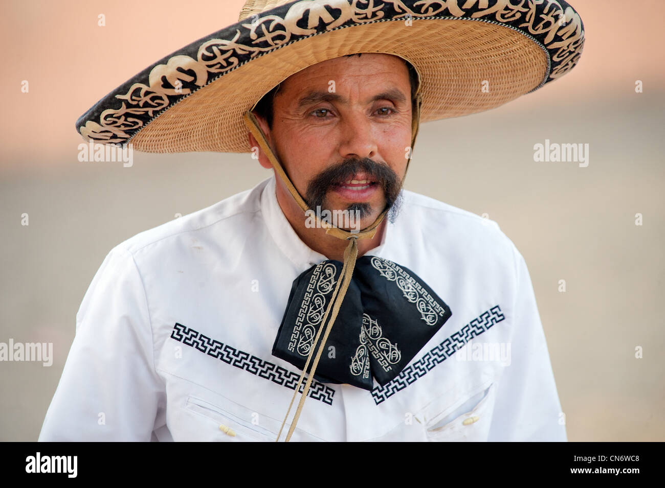 Mexican charro (horseman) with a handlebar moustache, wearing an ornate sombrero and traditional dress, San Antonio, TX, US Stock Photo