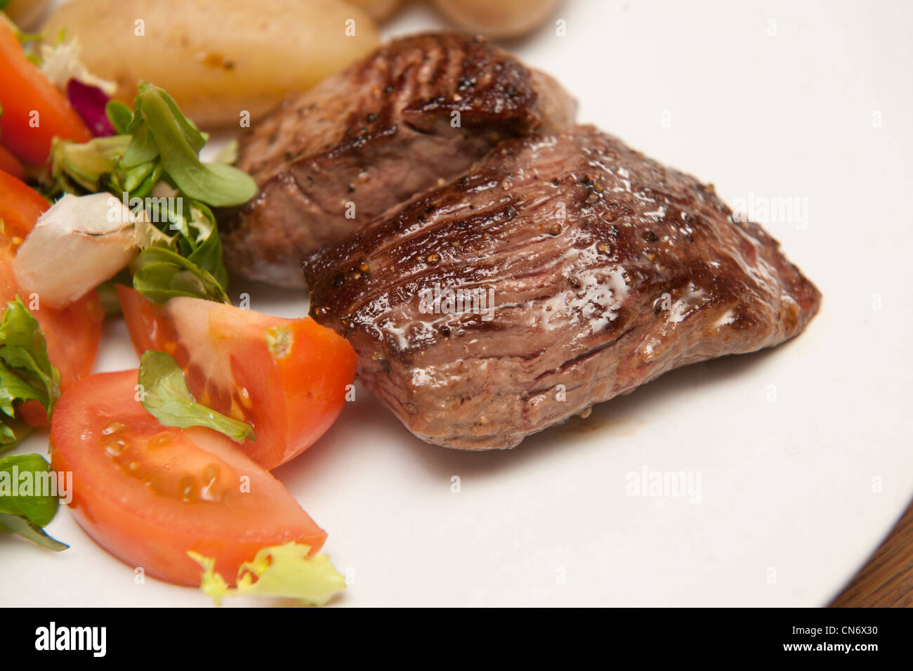 Cooked Reindeer steaks from Lidl supermarket on a plate with salad