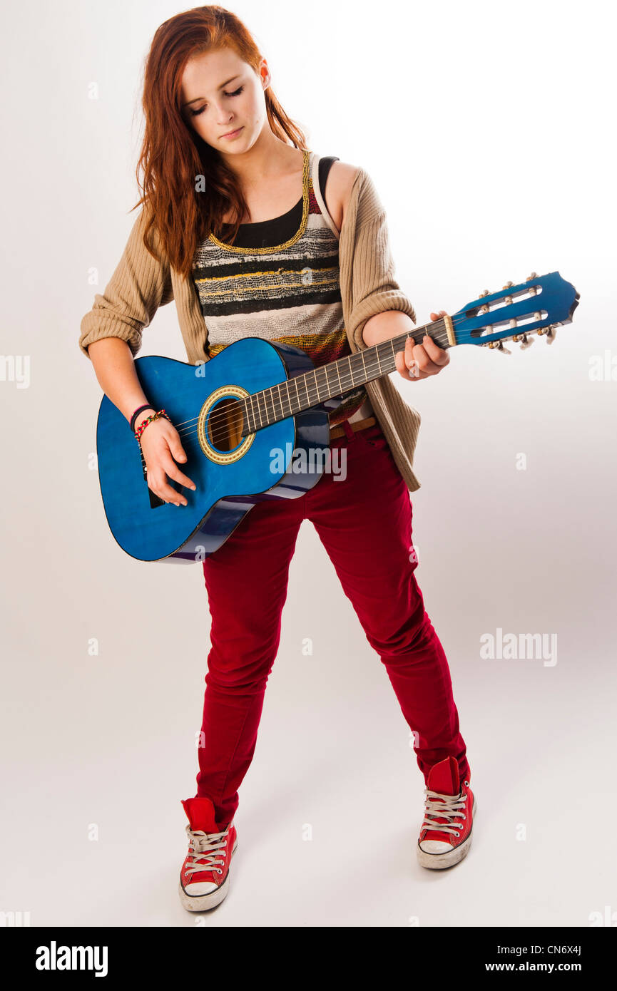 a thirteen year old teenage girl playing an acoustic guitar, UK Stock