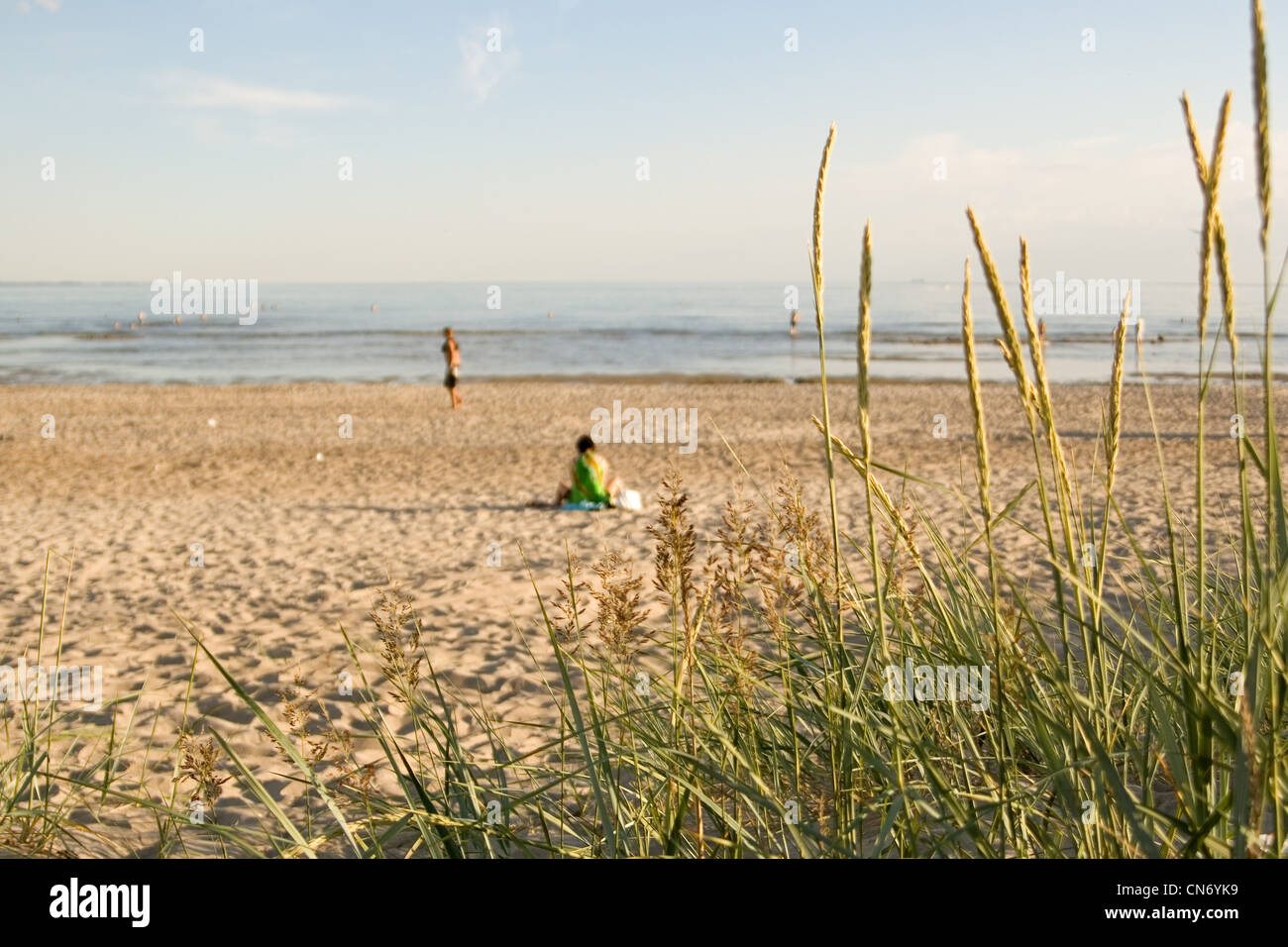 Few people at a quiet and tranquil beach at Pärnu Stock Photo