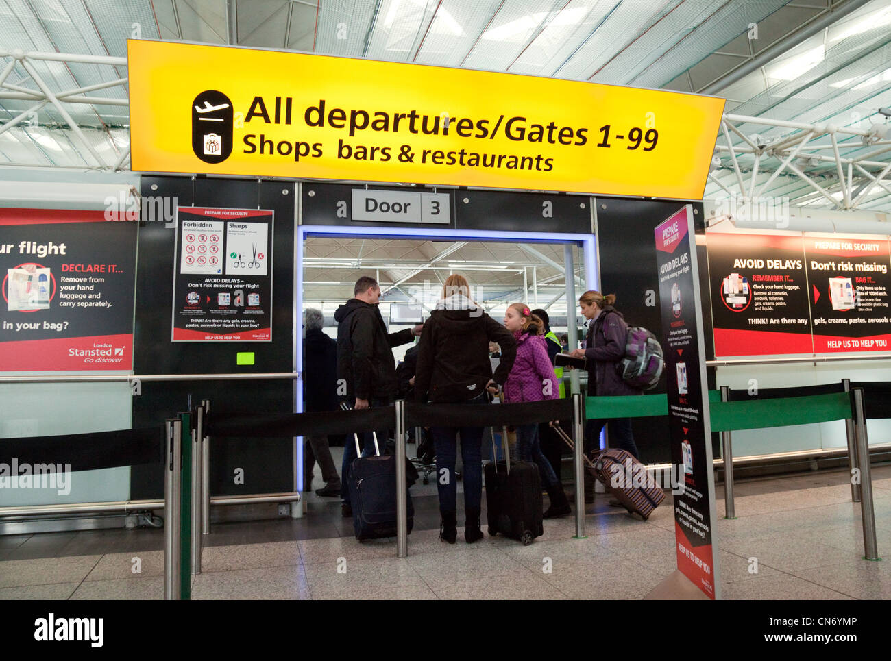 Air passengers going through security to Departures, Stansted airport Essex UK Stock Photo