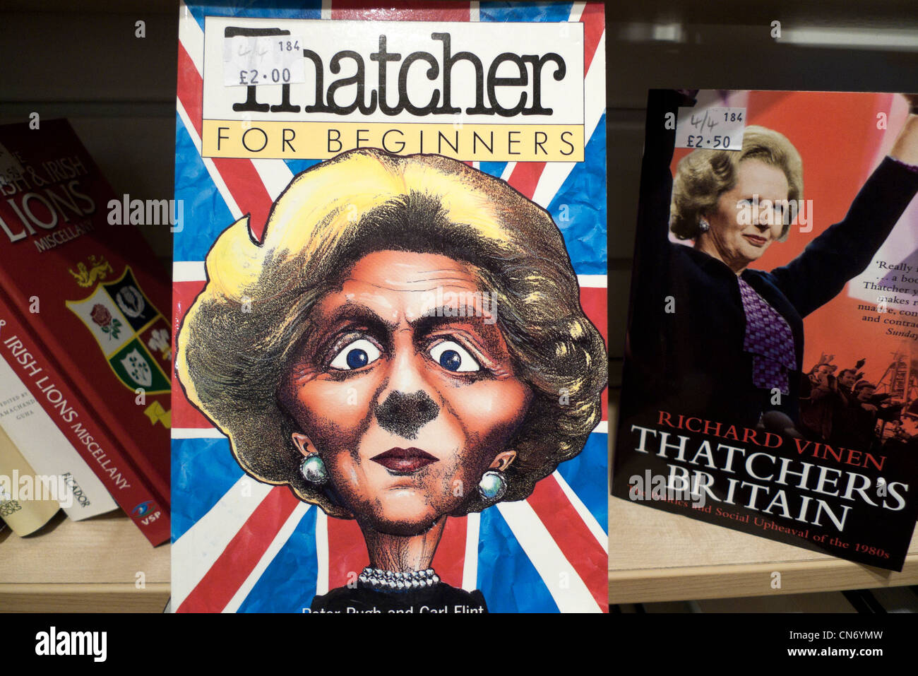 Margaret Thatcher PM 'Thatcher for Beginners' book cover and 'Thatcher's Britain' books on sale on a charity shop bookshelf Britain UK   KATHY DEWITT Stock Photo