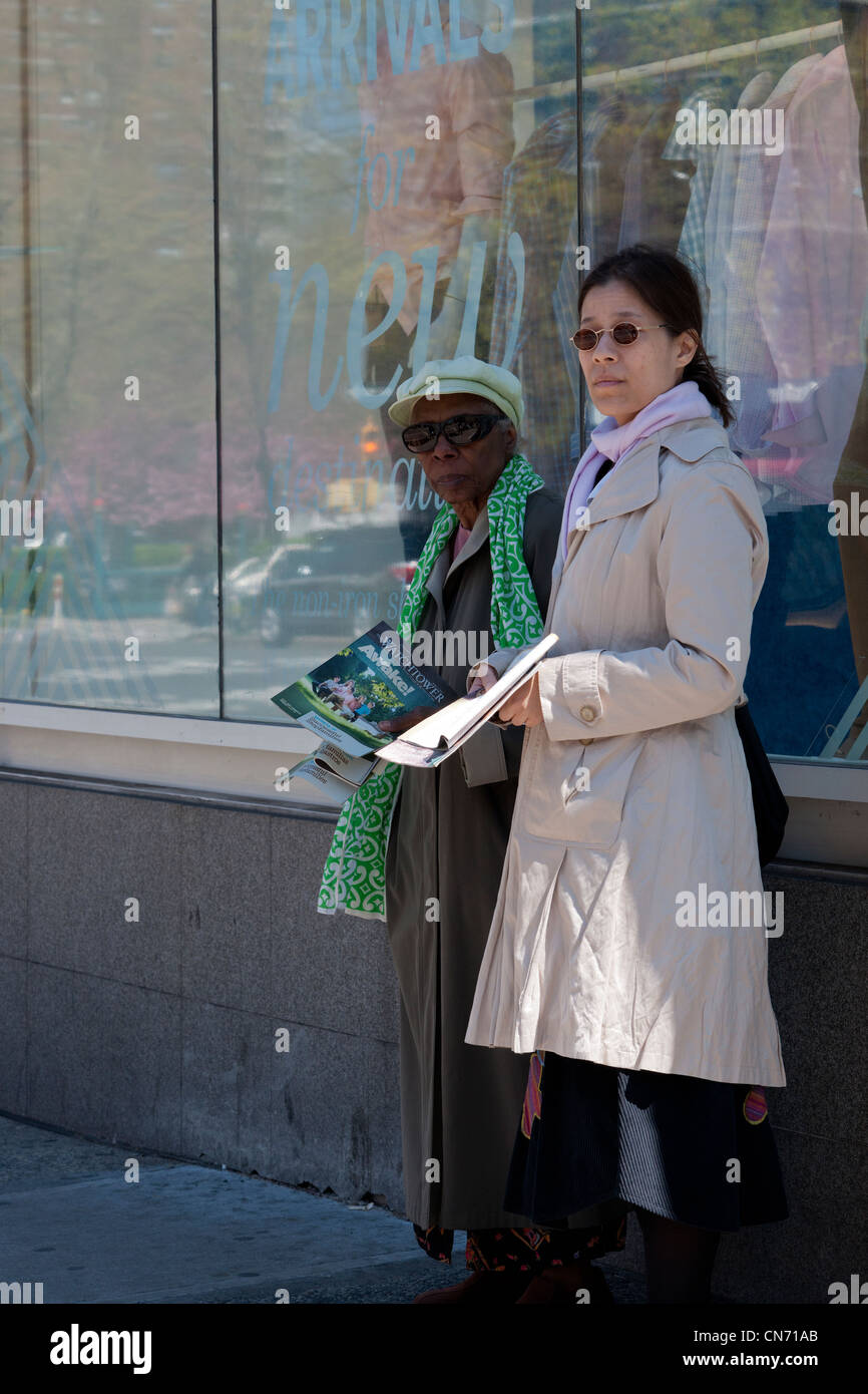 Jehovah's Witnesses hand out copies of the Watchtower an Awake in the Chelsea neighborhood of New York Stock Photo