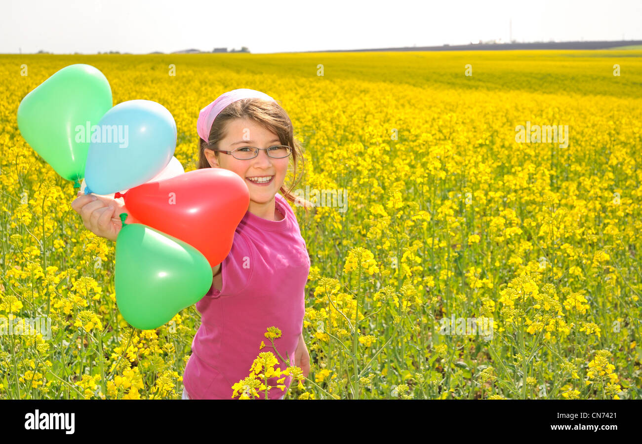 Little girl with balloons on field Stock Photo - Alamy