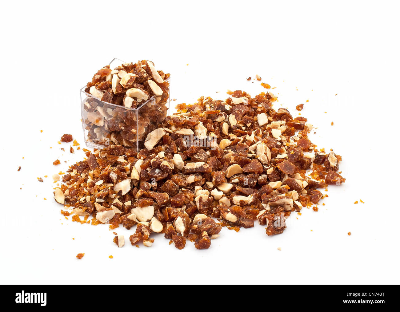 Caramelized crumbled Almonds for topping on white background Stock Photo