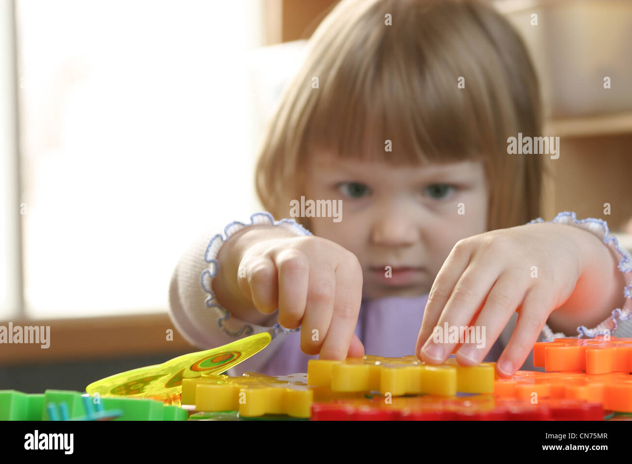Girl Playing with Toys Stock Photo - Alamy