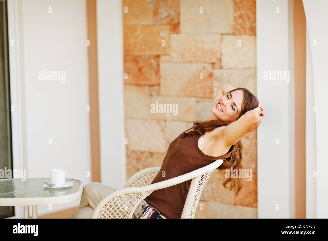Beautiful woman relaxing on terrace Stock Photo - Alamy
