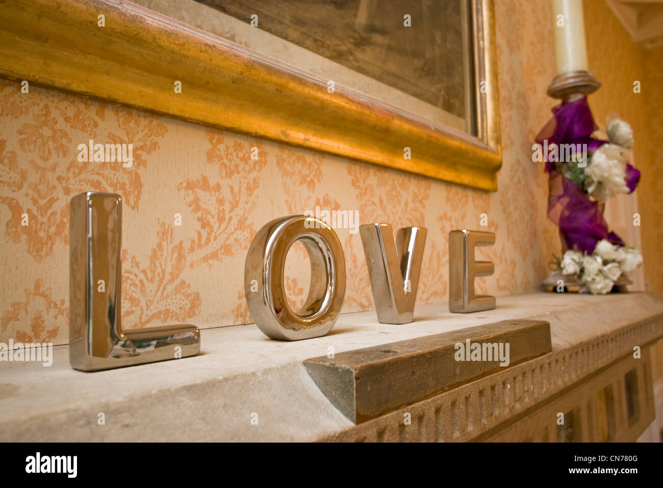 Silver metal letters spelling the word Love on a mantle piece at a wedding Stock Photo