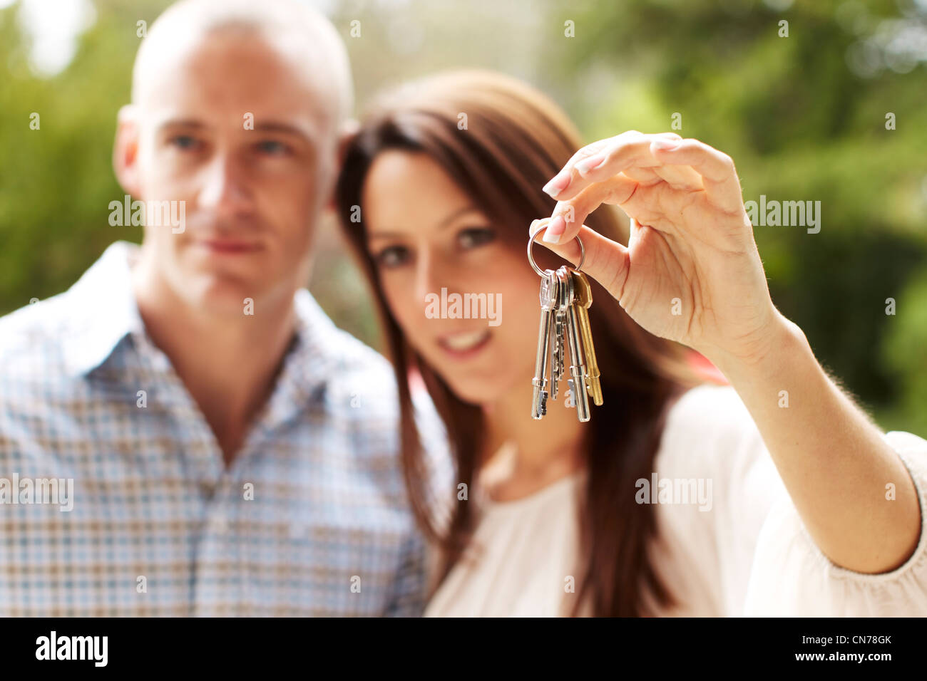 Couple holding keys Stock Photo