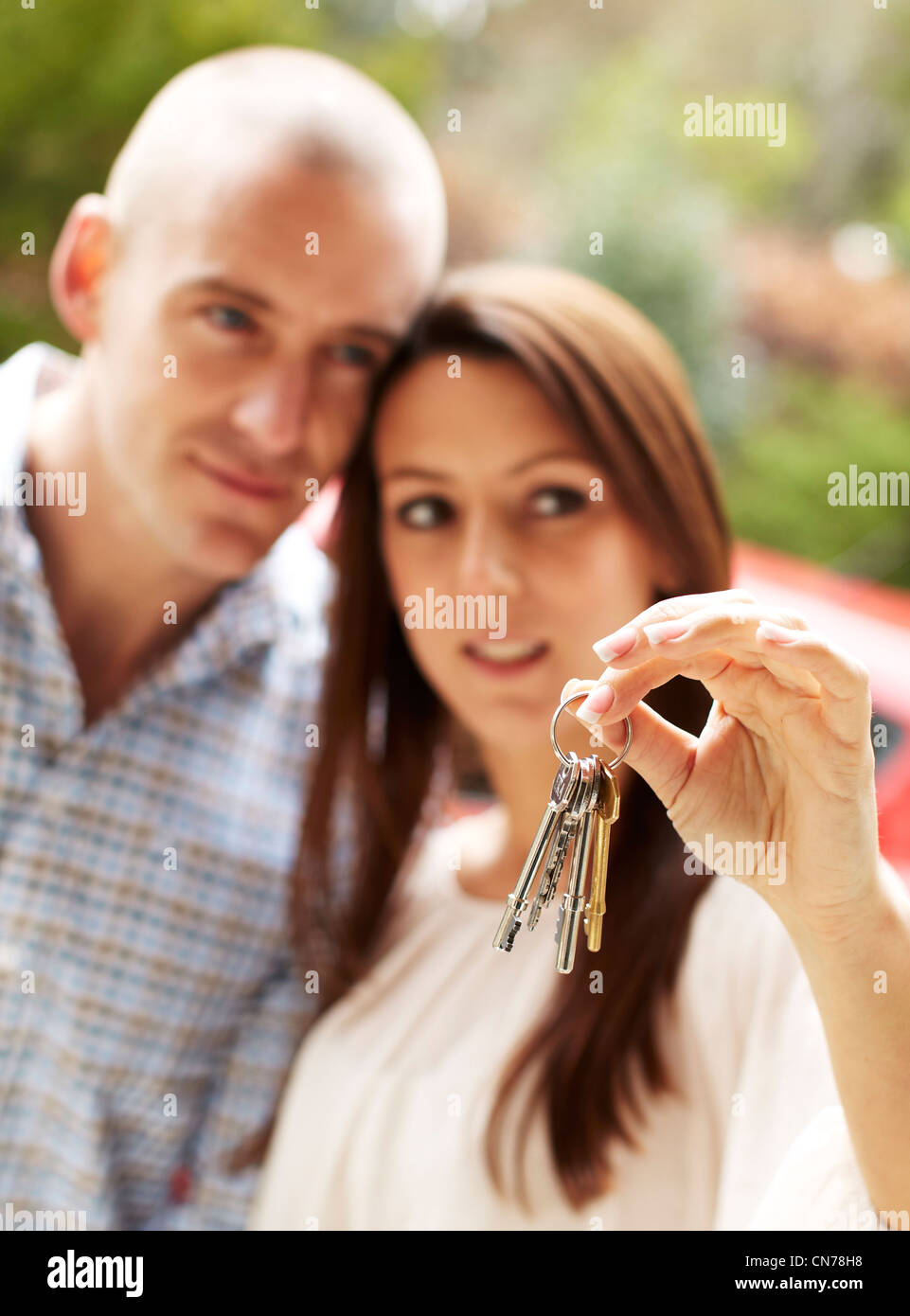 Couple holding keys Stock Photo