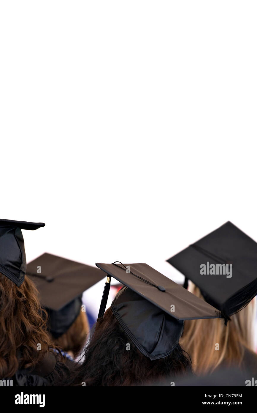 Graduation caps and gowns isolated over a white background. Stock Photo
