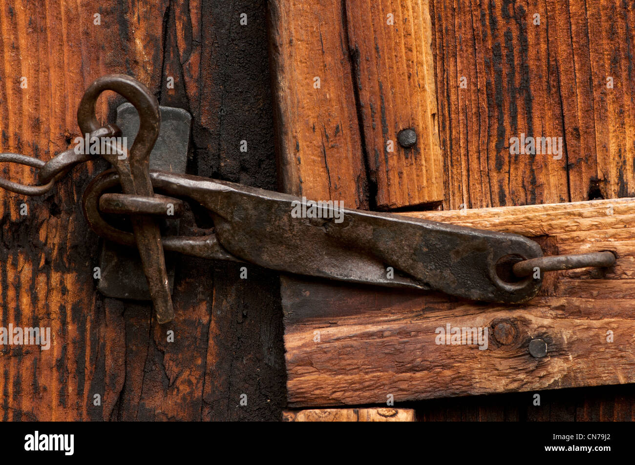 Hand-forged metal latch on barn door Stock Photo