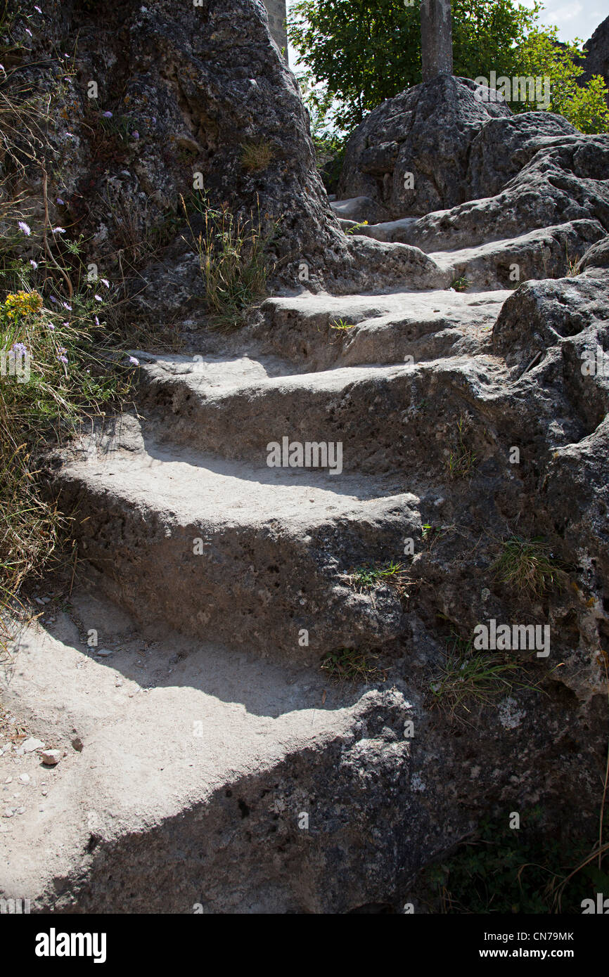 Stone steps worn down by centuries of people climbing to the church, Cite de la Couvertoirade, France Stock Photo