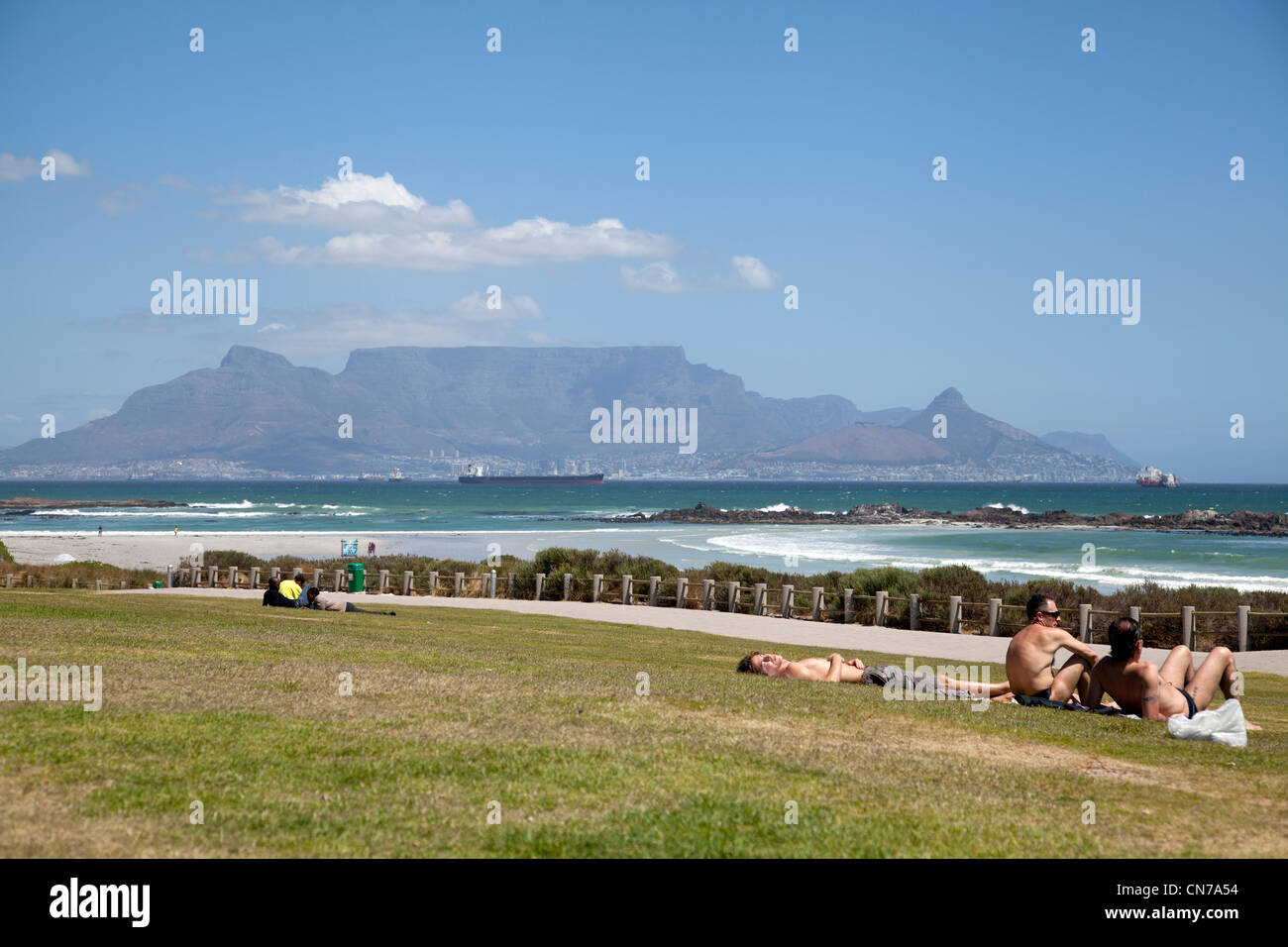 Lying on lawn at Big Bay in Cape Town Stock Photo