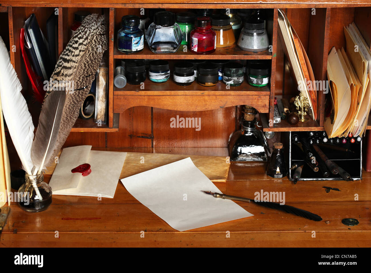 Old writing desk full of quills & inks for calligraphy Stock Photo