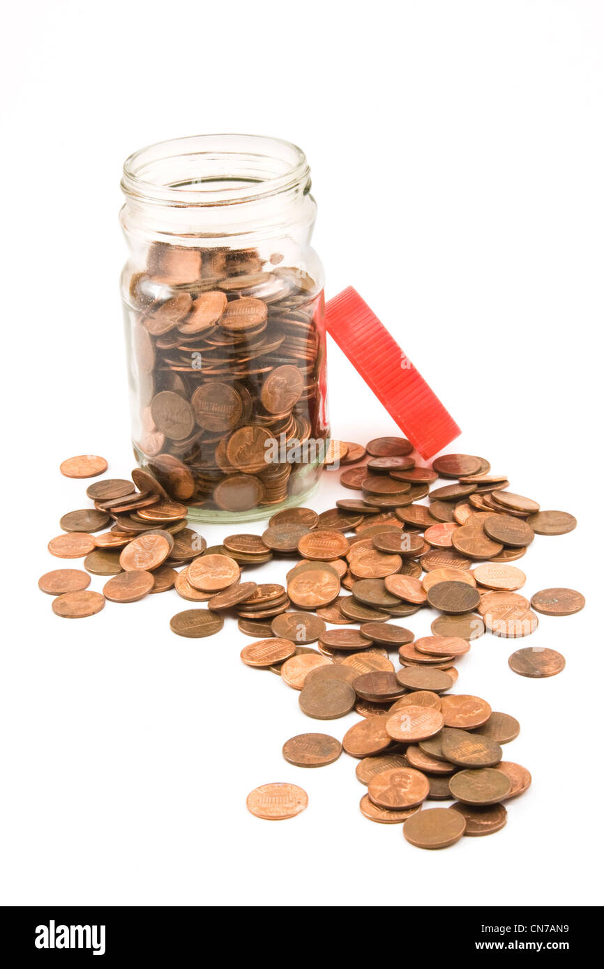 Pennies and jar on white background. Stock Photo