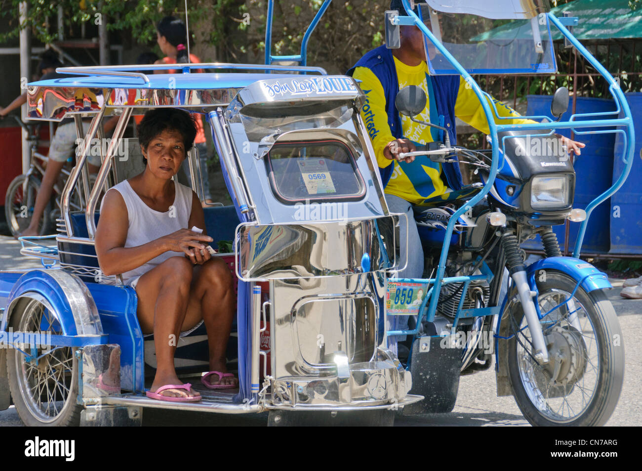 Asian senior woman in side-car tricycle malr driver Street Scene Puerto Galera, Oriental Mindoro, Philippines, Southeast Asia Stock Photo