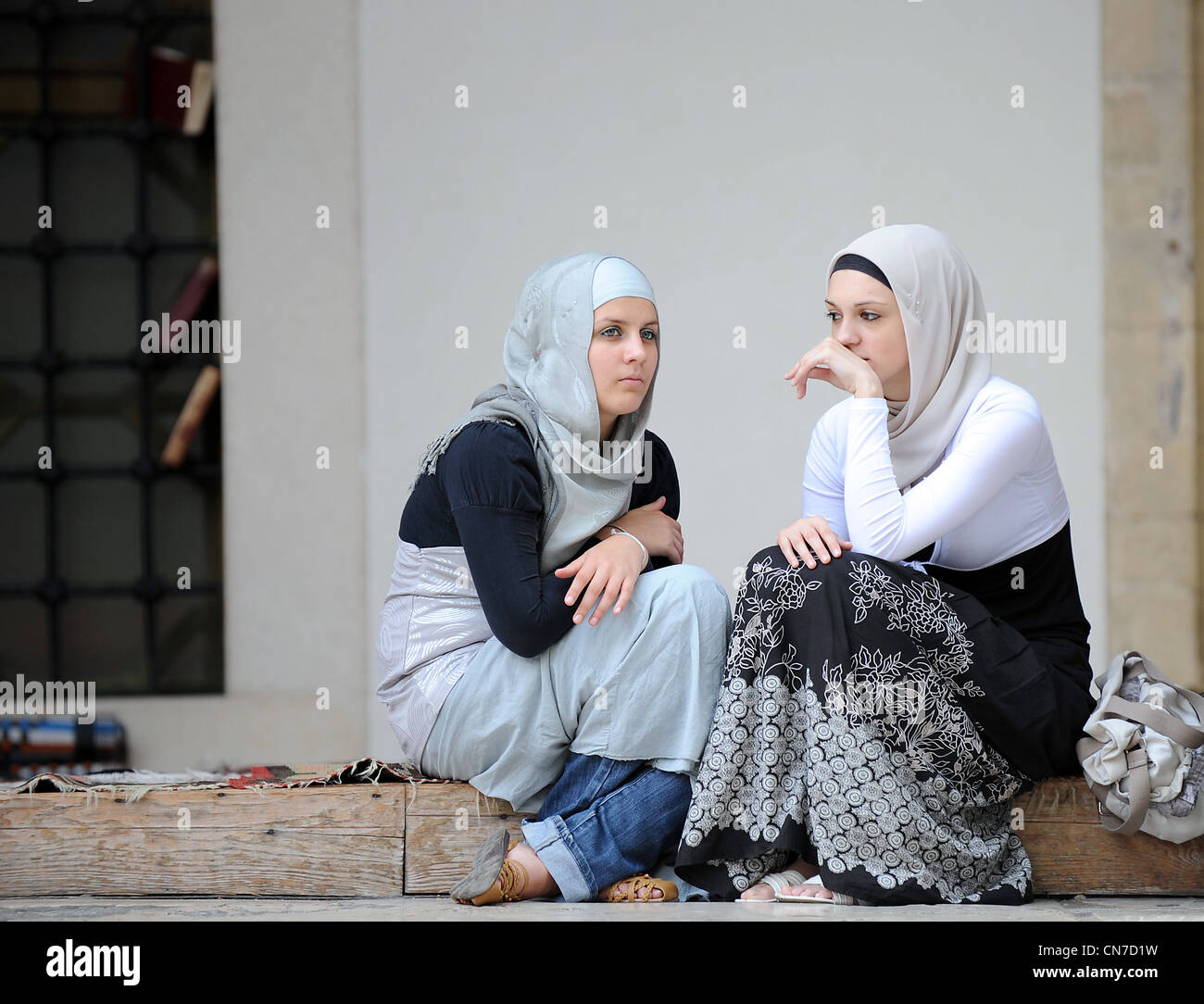 Bosnian Muslim women sits in front of Gazi Husrev Bey mosque in Sarajevo Stock Photo