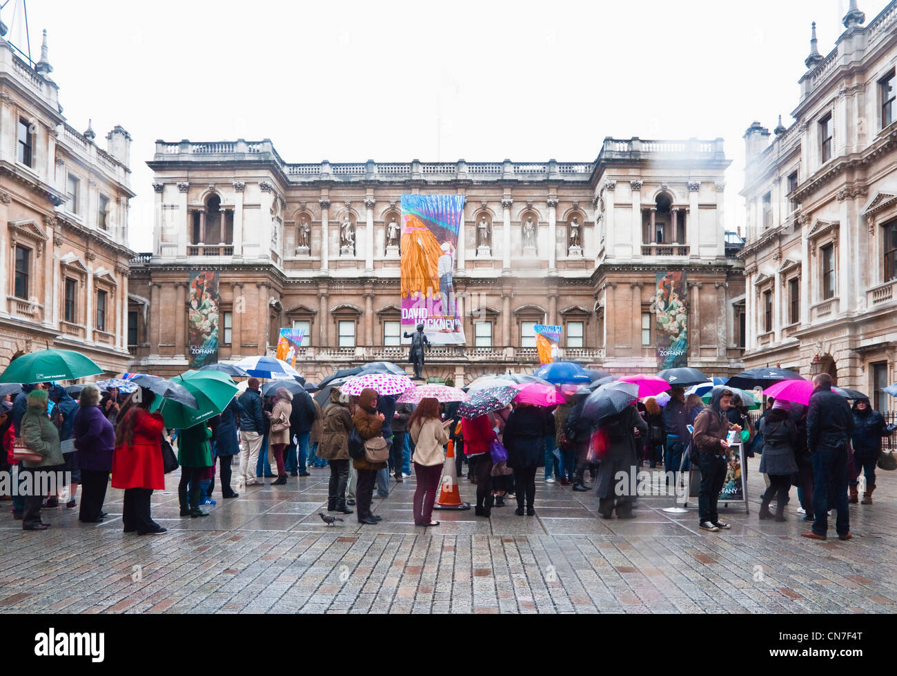 Queuing in the rain to gain admittance on the very last day of David Hockneys' popular and memorable exhibition.  April 2012. Stock Photo
