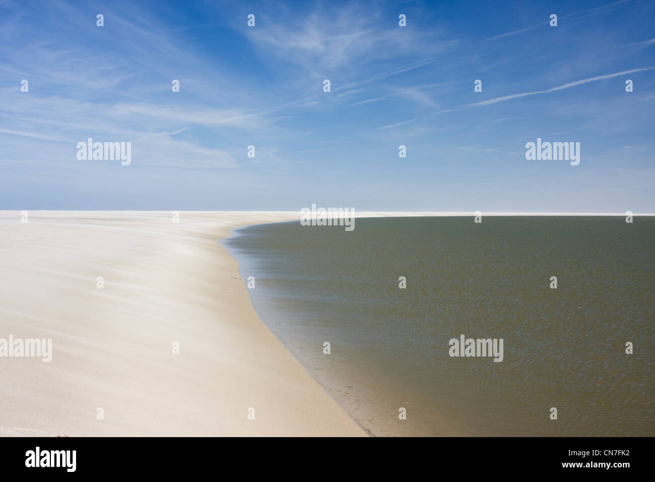 Remote beach on the island Schiermonnikoog in the northern part of the Netherlands with cirrus clouds in the blue sky. Stock Photo