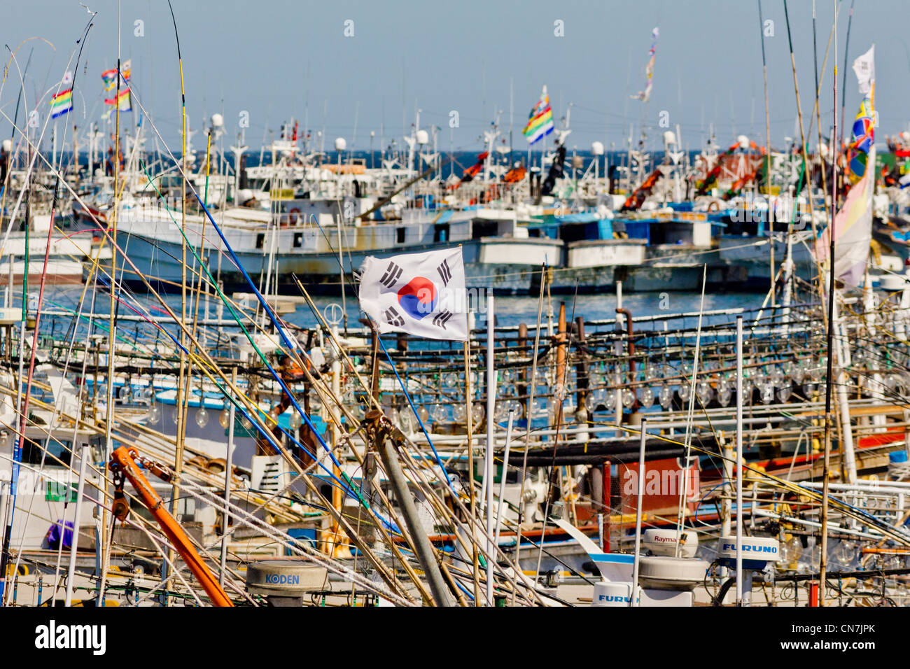 South Korea, Jeju Province, Seongsan, Korean flag (Taegukgi) and details of fishing boats masts in the port of Seongsan Stock Photo