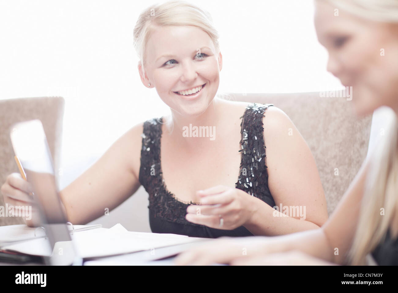Businesswomen at conference table Stock Photo