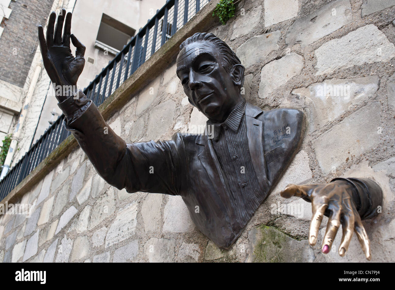 France, Paris, Montmartre, Passe Muraille statue frozen in the wall of the Place Marcel Ayme (Marcel Ayme square), performed by Stock Photo