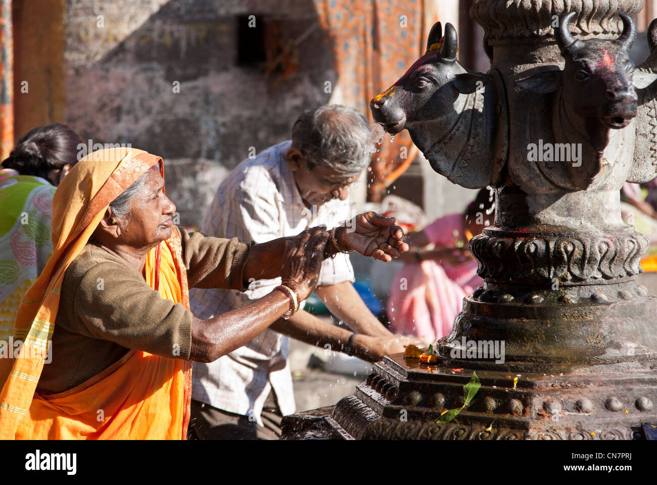 Hindu woman washing her hands with the water of the sacred fountain. Ram Kund. Nasik. India Stock Photo