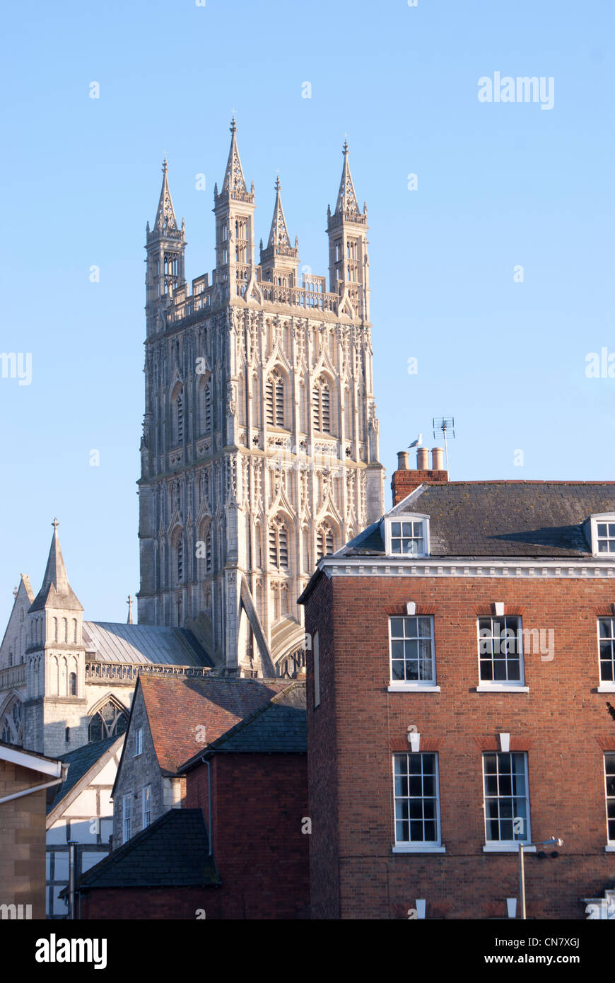Gloucester Cathedral tower, Gloucester, England seen behind historic buildings in the centre of old Gloucester Stock Photo