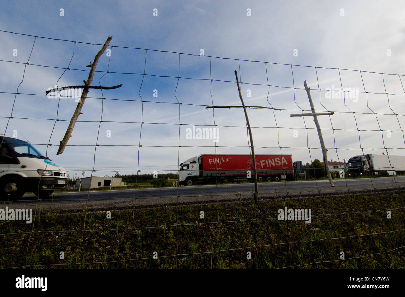 Spain, Galicia, Lavacolla, wooden crosses hanged on the fence of the expressway Stock Photo
