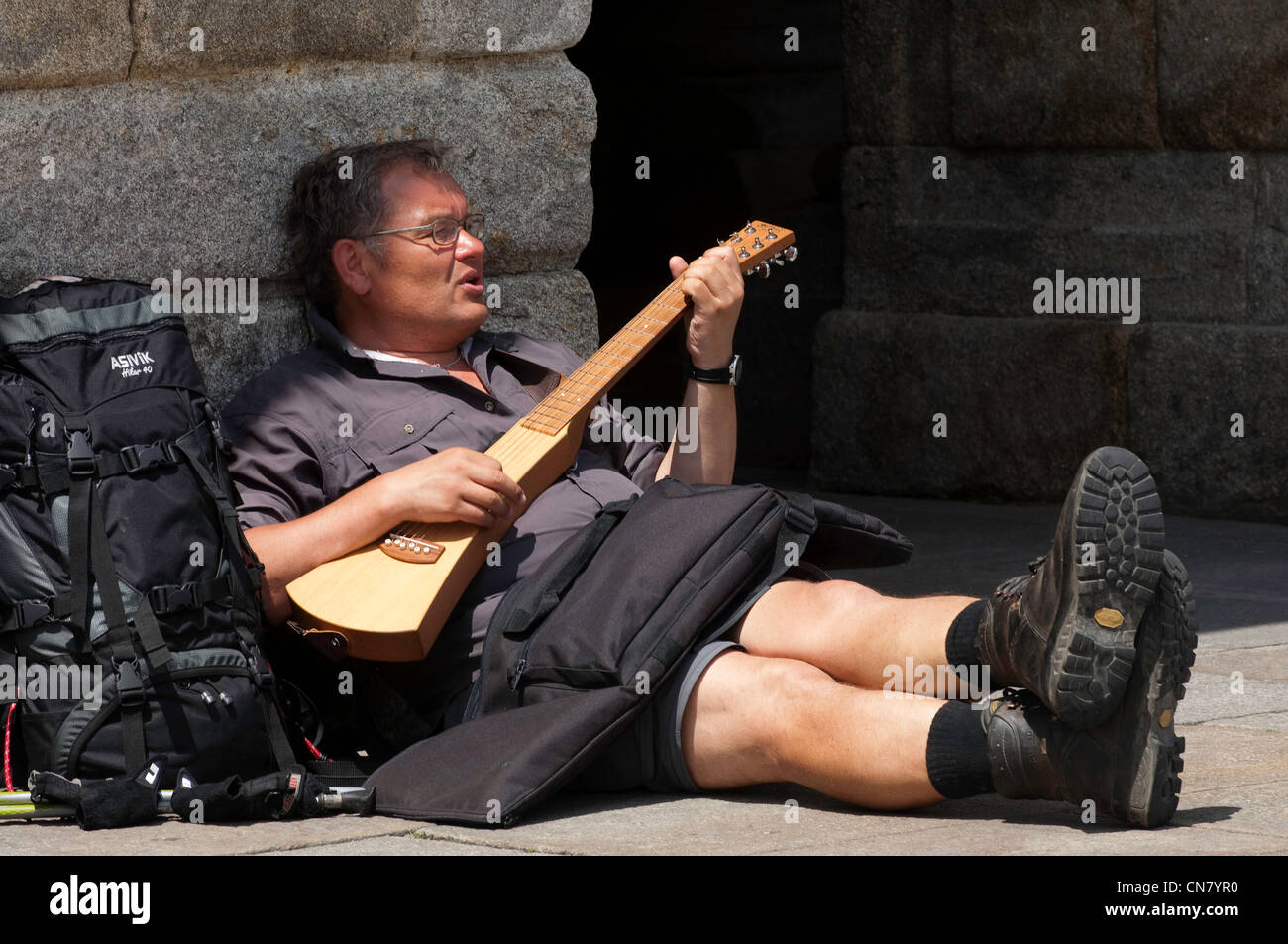 Spain, Galicia, Santiago de Compostela, listed as World Heritage by UNESCO, pilgrim playing the guitar on the Plaza de Stock Photo