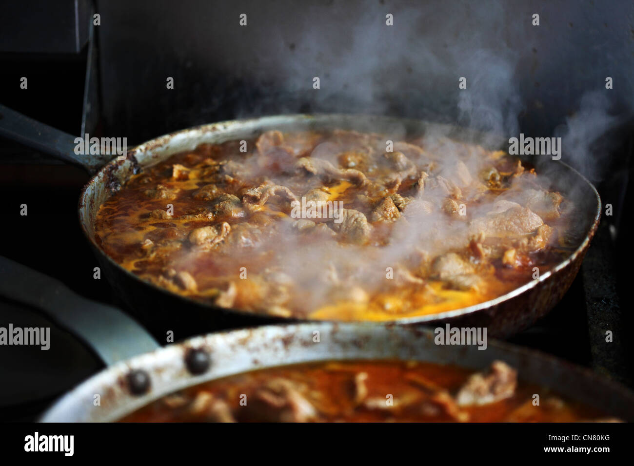Bifanas are cooked in a pan in central Lisbon, Portugal. Stock Photo