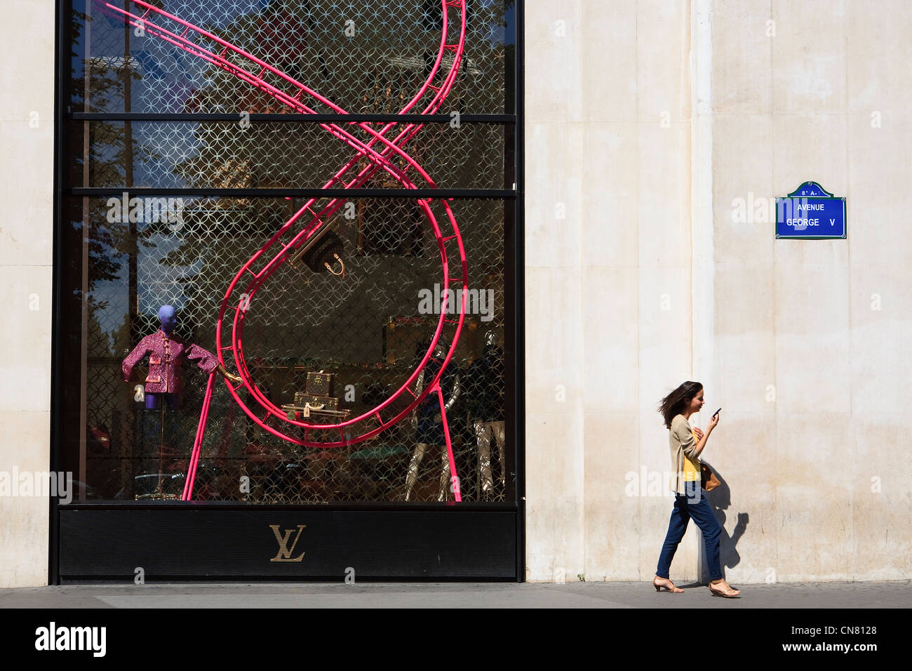 People in front of Louis Vuitton Maison Champs Élysées in Paris