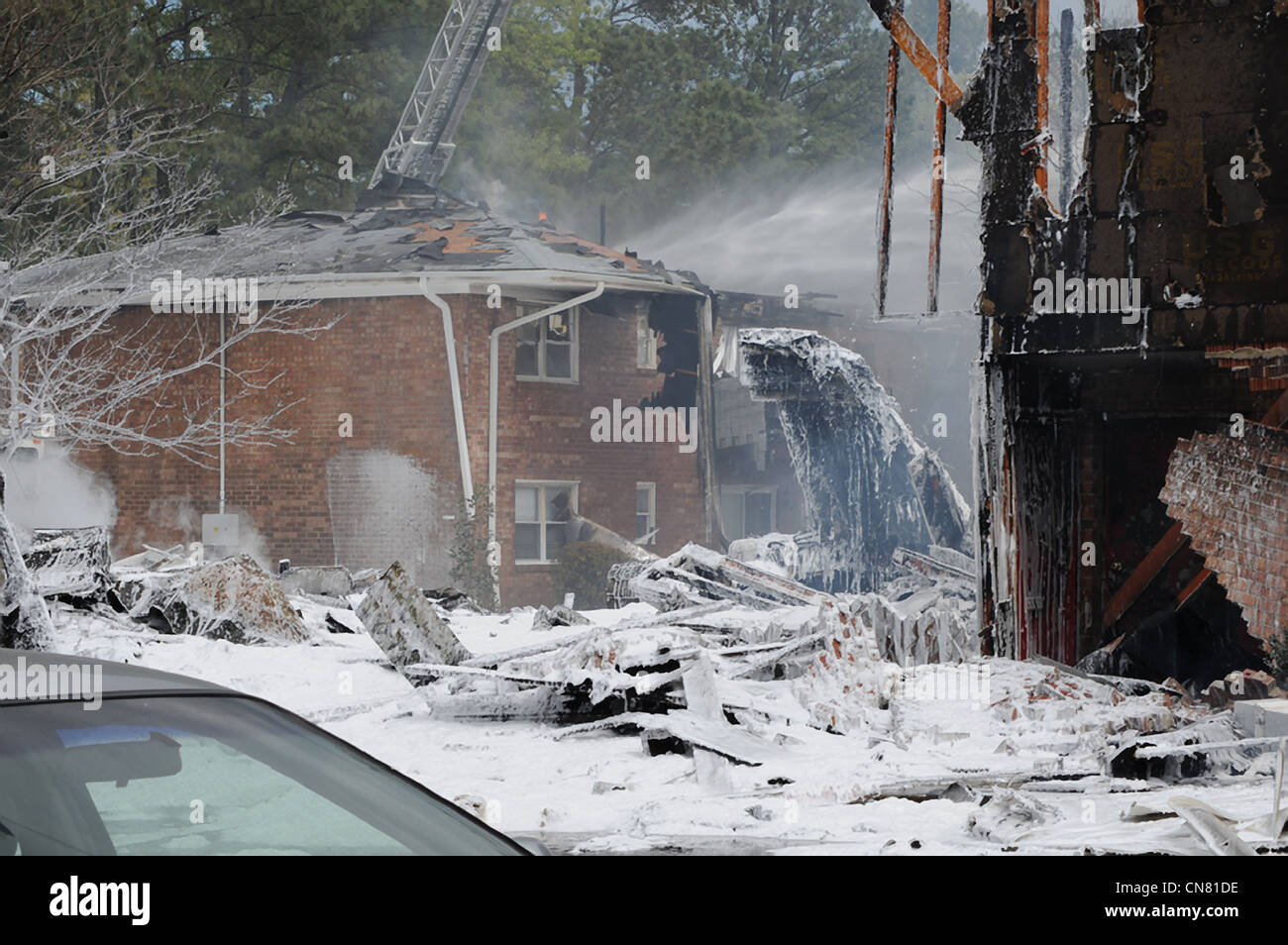 Firefighting foam covers the scene of a crash where a US Navy F-18 aircraft crashed after taking off from Naval Air Station Oceana April 6, 2012 in Virginia Beach, VA. Stock Photo