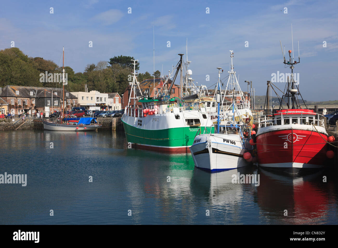 Padstow, Cornwall, England, UK. Village harbour scene with fishing boats moored on Cornish coast Stock Photo