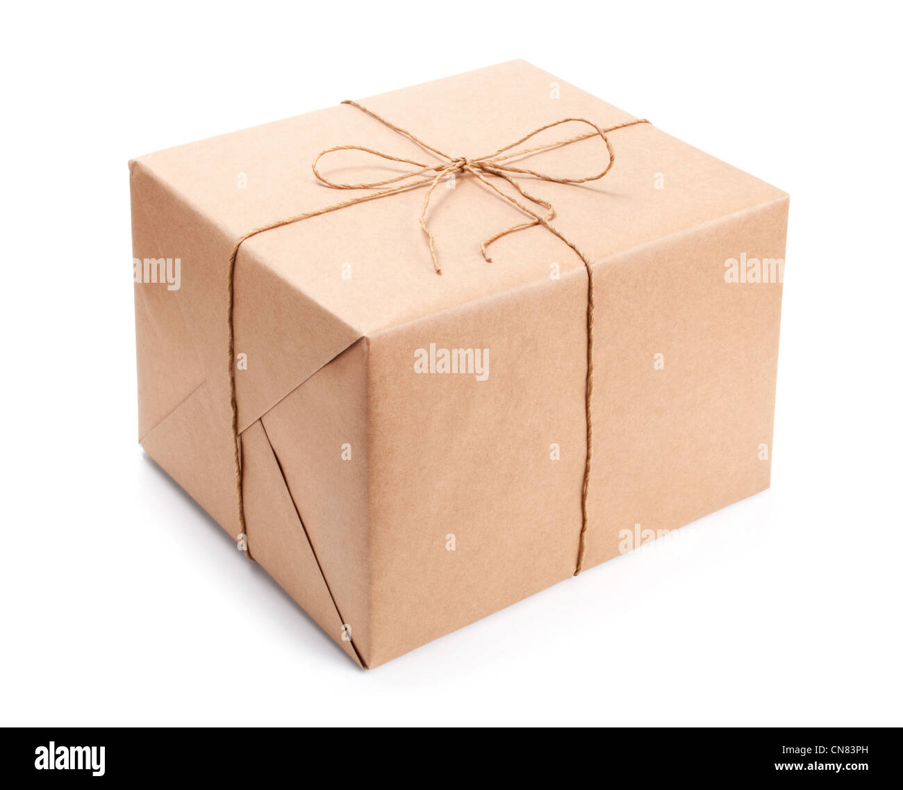 Parcel wrapped with brown packing paper tied with twine isolated on white Stock Photo
